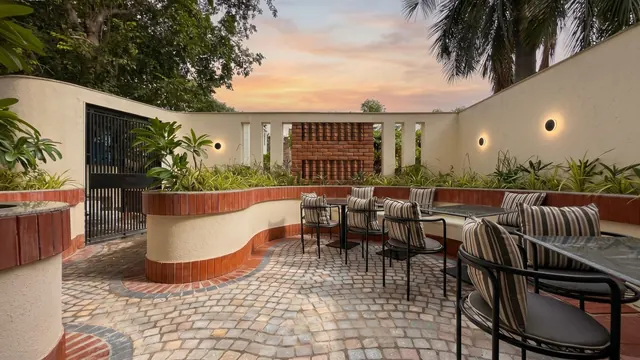 Wide view of the courtyard with seating and soft wall lights