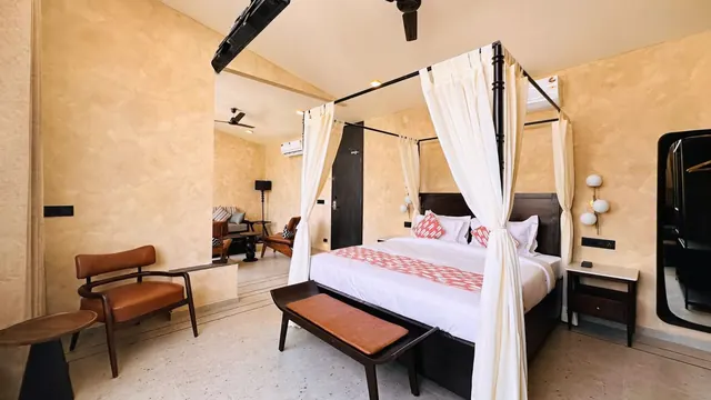 Luxury Suite with Balcony: canopied four-poster bed, leather armchairs and a separate seating area