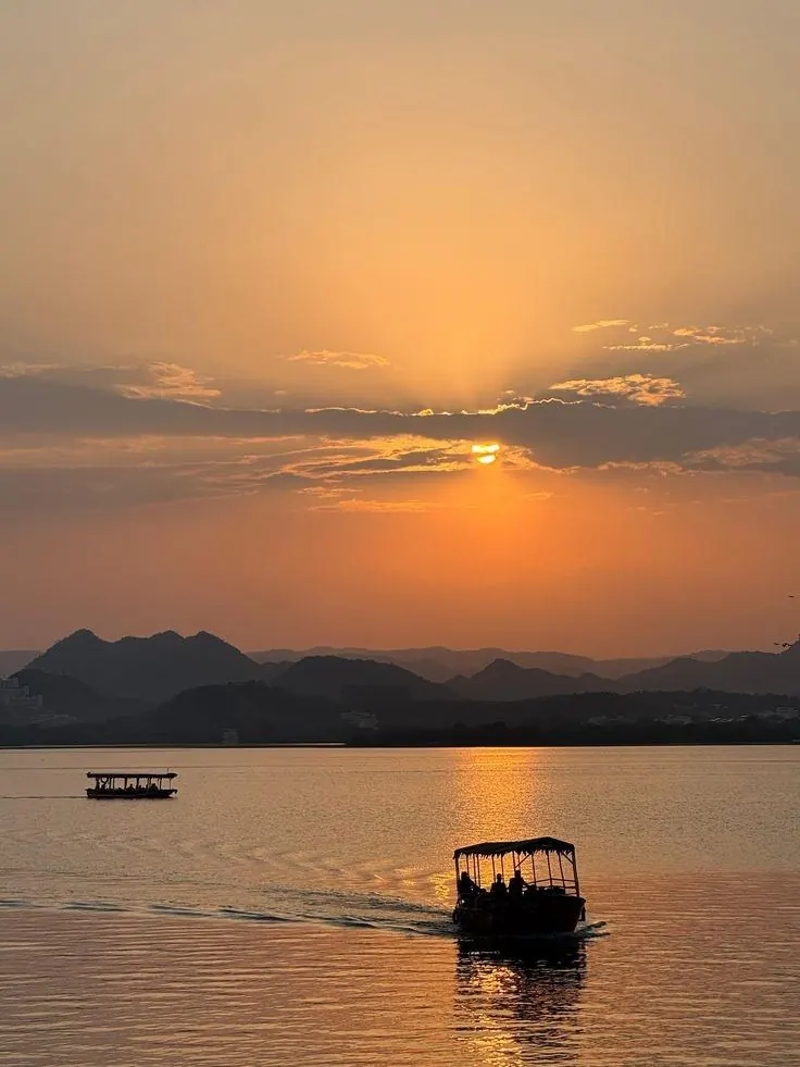 Sunset over Fateh Sagar Lake in Udaipur with a boat on the water